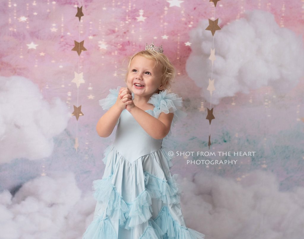 child girl in blue dress with princess background