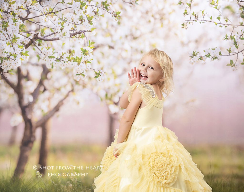 little girl in yellow dollcake dress with floral background, atlanta Georgia child photographer