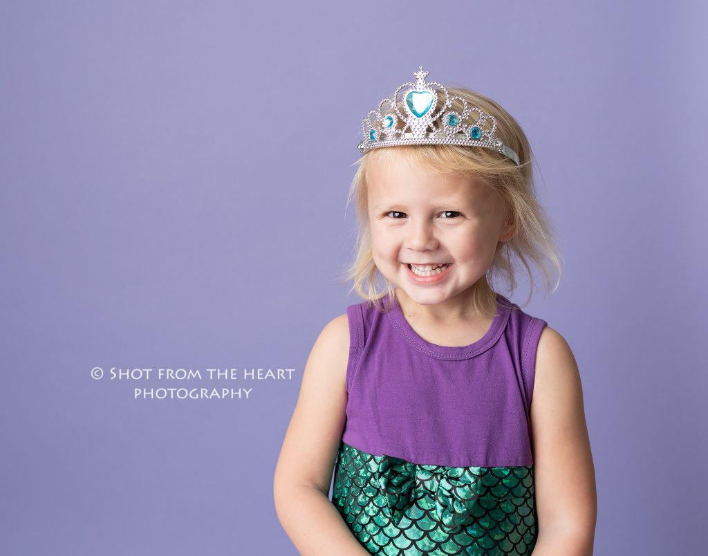 little girl in green and purple mermaid outfit with purple background, atlanta Georgia child photographer
