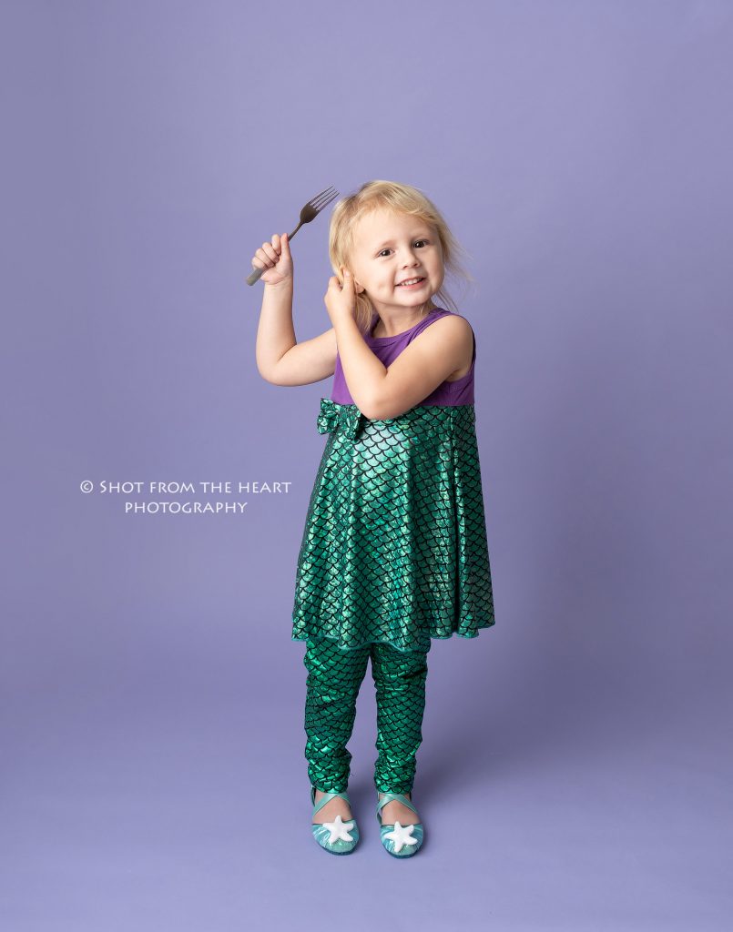 little girl in green and purple mermaid outfit with purple background, atlanta Georgia child photographer