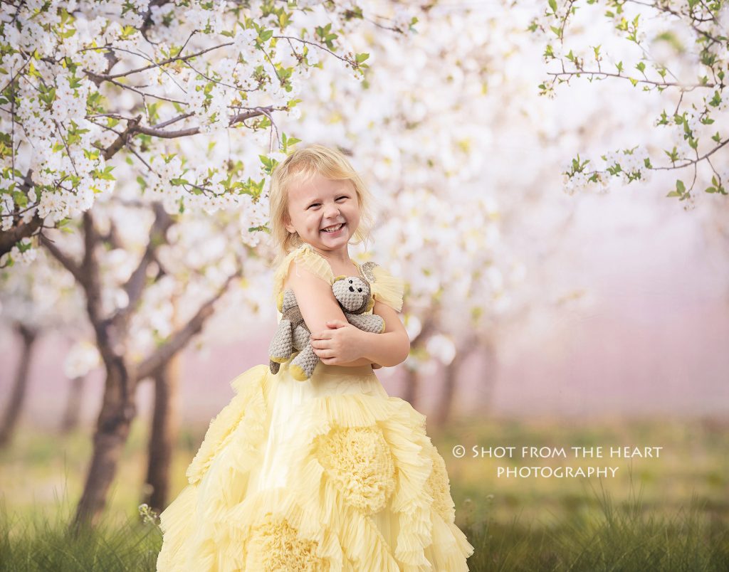 little girl in yellow dollcake dress with floral background, atlanta Georgia child photographer