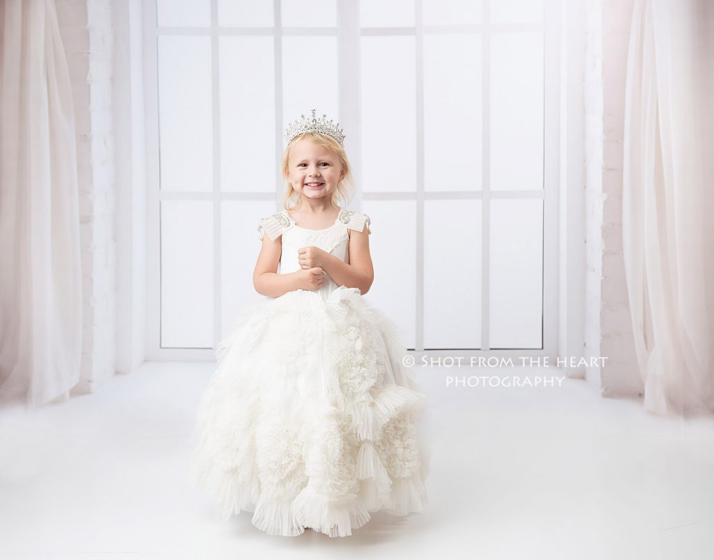 little girl in white dollcake dress with white window background, atlanta Georgia child photographer