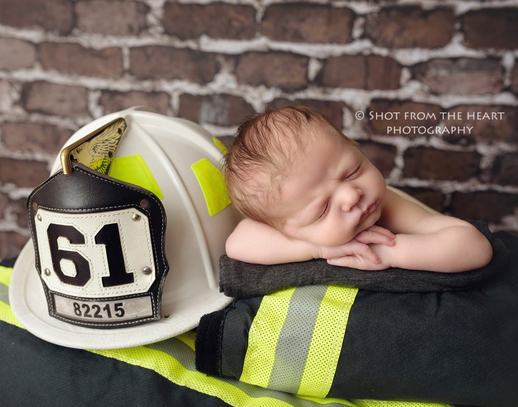 newborn baby photography with firefighter turnout bunker gear