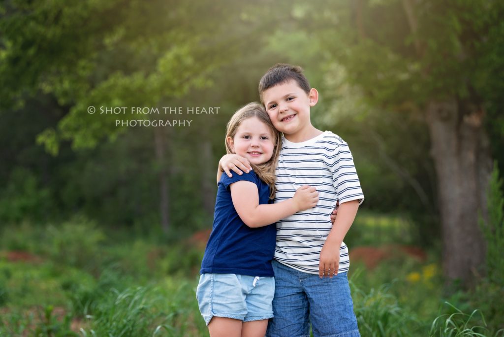 brother and sister standing in their backyard photography session in Cartersville Georgia