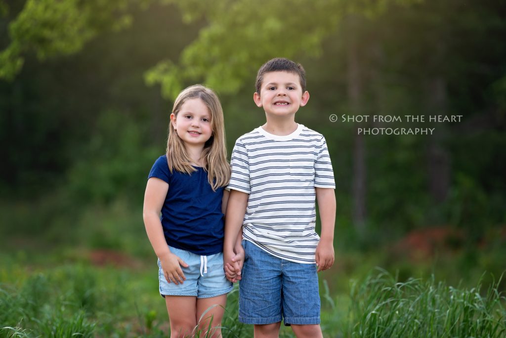 brother and sister standing in their backyard photography session in Cartersville Georgia