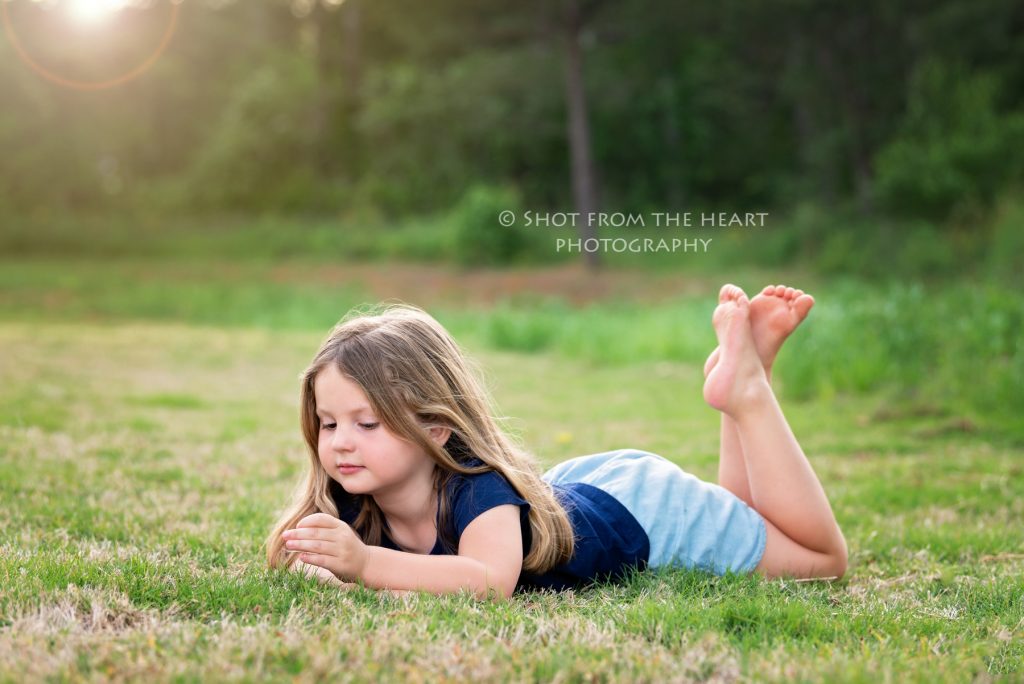 girl laying in grass, child photographer, Cartersville Georgia