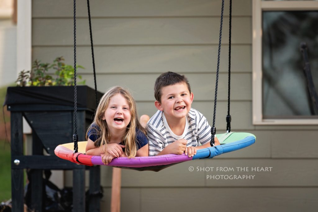 children playing on disc swing, front porch photography session, Cartersville Georgia 
