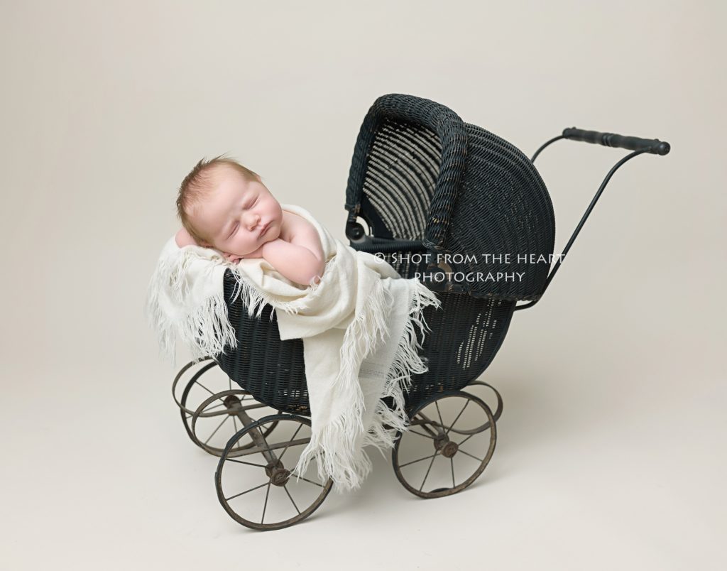 newborn baby photography in vintage antique pram stroller