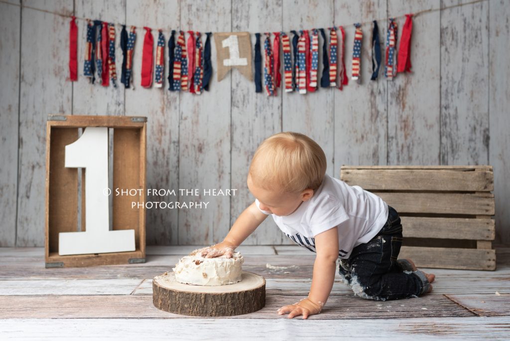 first birthday session. Patriotic, rustic backdrop, cake smash. canton Georgia baby photographer. 