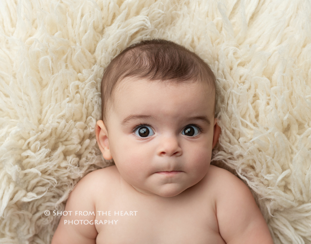 expressive baby photography on float cream rug