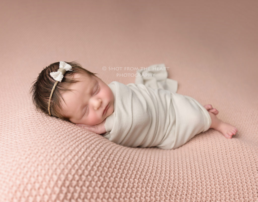 newborn baby photography swaddle on beanbag simple pink rustic